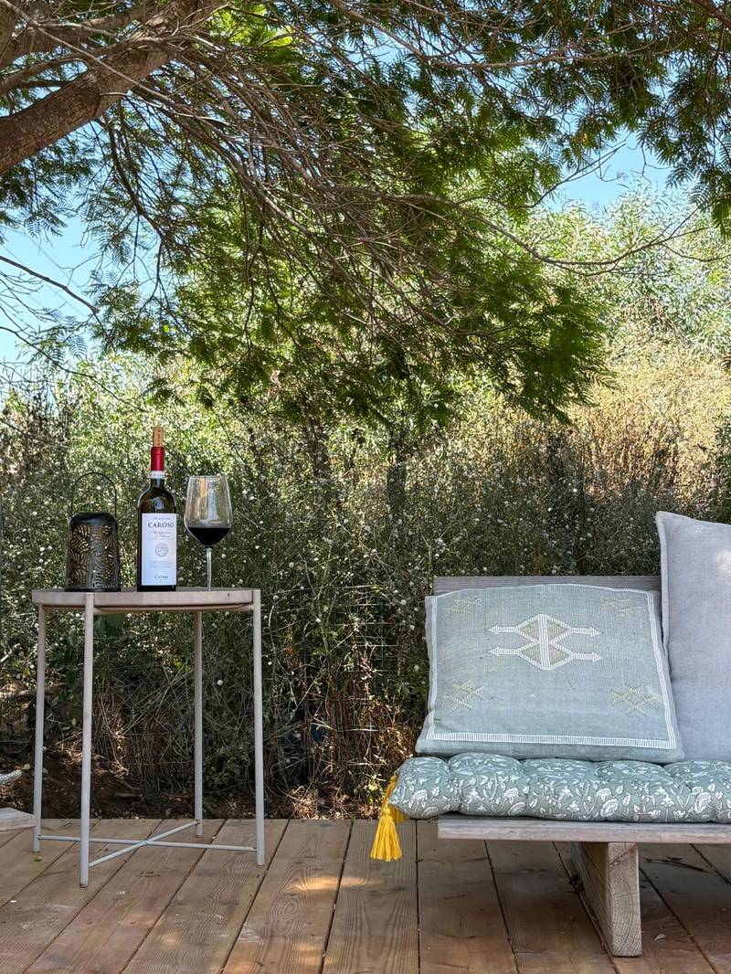 Wine and glasses on a side table beside the spa lounger